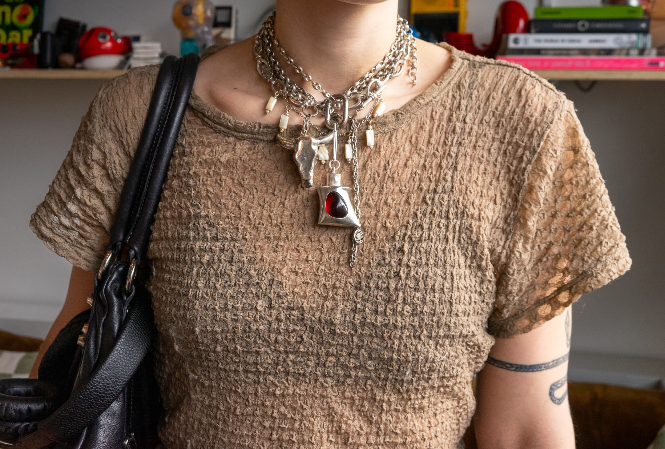 PUFF worn as a necklace with many chains.